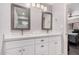Modern bathroom features dual sinks, white cabinets, and decorative mirrors at 6480 N 82Nd St # 1136, Scottsdale, AZ 85250
