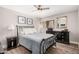 Cozy bedroom features a wrought iron bed frame, wood floors, ceiling fan, and tasteful decor at 6480 N 82Nd St # 1136, Scottsdale, AZ 85250