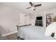 Neutral bedroom with a ceiling fan, wood floors, and adjoining bathroom and closet at 6480 N 82Nd St # 1136, Scottsdale, AZ 85250