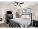 Bedroom with wood floors, ceiling fan, tasteful art, and a neutral color palette at 6480 N 82Nd St # 1136, Scottsdale, AZ 85250