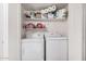 Functional laundry room with washer, dryer, and ample shelving for storage, simplifying household chores at 6480 N 82Nd St # 1136, Scottsdale, AZ 85250