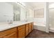 Spacious bathroom featuring a double vanity, soaking tub, and a separate shower at 6620 S 16Th Dr, Phoenix, AZ 85041