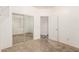 Bright bedroom with mirrored closet doors and an open doorway to another room at 6620 S 16Th Dr, Phoenix, AZ 85041