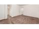 Large bedroom featuring neutral carpet, an attached bathroom, and walk-in closet at 6620 S 16Th Dr, Phoenix, AZ 85041