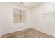 Bedroom with neutral carpet and walls, and a window with blinds at 6620 S 16Th Dr, Phoenix, AZ 85041