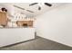 Open-concept dining room and kitchen with modern light fixtures and tile floors at 6620 S 16Th Dr, Phoenix, AZ 85041