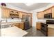 Charming kitchen features stainless steel appliances, wood cabinets, and ample counter space at 6620 S 16Th Dr, Phoenix, AZ 85041