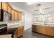 Spacious kitchen with wood cabinets, stainless steel appliances and adjacent dining area at 6620 S 16Th Dr, Phoenix, AZ 85041