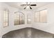 Bright living room with tile floors, ceiling fan, and multiple windows at 6620 S 16Th Dr, Phoenix, AZ 85041