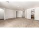 Expansive living room with neutral carpet and arched doorways, offering a versatile space at 6620 S 16Th Dr, Phoenix, AZ 85041