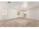 Spacious living room with neutral carpet, large windows, and ample natural light at 6620 S 16Th Dr, Phoenix, AZ 85041