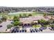 Aerial view of a community clubhouse, lake and golf course in a Primary-planned community at 7050 S Fawn Ave, Gilbert, AZ 85298