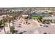 Aerial view of a community center with an American flag, tennis courts, and landscaping at 7050 S Fawn Ave, Gilbert, AZ 85298