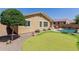 Backyard features a pool, putting green and desert landscaping under blue skies at 7050 S Fawn Ave, Gilbert, AZ 85298