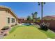 Relaxing backyard featuring a pool, putting green and desert landscaping at 7050 S Fawn Ave, Gilbert, AZ 85298