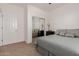 Well-lit bedroom showcases a full bed, mirrored closet, and neutral carpet at 7050 S Fawn Ave, Gilbert, AZ 85298