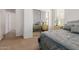 Bright bedroom with a mirror closet and a soft blue quilt-covered bed at 7050 S Fawn Ave, Gilbert, AZ 85298