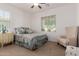 Cozy bedroom featuring a full bed, a nightstand, and a sitting chair under a window at 7050 S Fawn Ave, Gilbert, AZ 85298