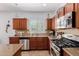 Bright kitchen showcasing stainless steel appliances, stylish backsplash, and a view of the neighborhood at 7050 S Fawn Ave, Gilbert, AZ 85298