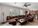 Spacious living room with a large sectional sofa, a coffee table, and direct kitchen access at 7050 S Fawn Ave, Gilbert, AZ 85298