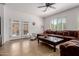 Bright living room with patio access, a comfortable sofa, tile flooring, and natural light at 7050 S Fawn Ave, Gilbert, AZ 85298