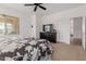 Spacious main bedroom with carpet, a ceiling fan, and a view of a dresser and TV at 7050 S Fawn Ave, Gilbert, AZ 85298