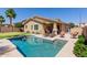 Inviting backyard pool with lounge chairs, putting green, and lush landscaping creating a relaxing outdoor oasis at 7050 S Fawn Ave, Gilbert, AZ 85298