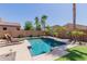 Refreshing pool area with lounge chairs, palm trees, and beautiful desert plants at 7050 S Fawn Ave, Gilbert, AZ 85298