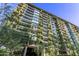 View of the high rise building featuring greenery covered balconies and modern architectural design at 7180 E Kierland Blvd # 811, Scottsdale, AZ 85254
