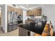 Spacious kitchen with stainless steel appliances, a kitchen island, and barstool seating at 7180 E Kierland Blvd # 811, Scottsdale, AZ 85254