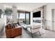 Modern living room with a decorative fireplace and sliding glass doors to the balcony at 7180 E Kierland Blvd # 811, Scottsdale, AZ 85254
