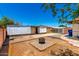 Backyard features a metal storage shed and a fire pit at 7360 N 38Th Dr, Phoenix, AZ 85051