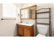 Bathroom features a vanity with a sink and toilet next to storage shelf at 7360 N 38Th Dr, Phoenix, AZ 85051