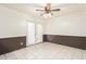 Cozy dining area with paneled walls, tiled flooring and access to patio at 7360 N 38Th Dr, Phoenix, AZ 85051