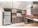 Functional kitchen with stainless steel refrigerator, brick accents, and practical layout at 7360 N 38Th Dr, Phoenix, AZ 85051