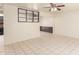 Open living space with tile floors, a ceiling fan, and view into the kitchen at 7360 N 38Th Dr, Phoenix, AZ 85051