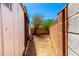A side yard is shown with gravel and a block fence at 7360 N 38Th Dr, Phoenix, AZ 85051