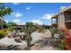 Beautifully landscaped community area with seating, mature trees, and covered parking at 7430 E Chaparral Rd # A222, Scottsdale, AZ 85250