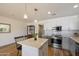 Bright kitchen with white cabinets, gray lower cabinets, stainless steel appliances, and quartz countertops at 7430 E Chaparral Rd # A222, Scottsdale, AZ 85250