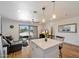 Light-filled living room with kitchen island, access to a balcony and an open floor plan at 7430 E Chaparral Rd # A222, Scottsdale, AZ 85250