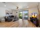 Bright living room with hardwood floors, a ceiling fan, and sliding glass doors to the outside at 7430 E Chaparral Rd # A222, Scottsdale, AZ 85250