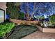 The beautifully landscaped backyard features a grass area, brick patio, and elegant greenery at 7596 N Via De La Siesta --, Scottsdale, AZ 85258