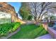 Backyard with lush green lawn, mature trees, and a well-maintained landscape for relaxing and enjoying the outdoors at 7596 N Via De La Siesta --, Scottsdale, AZ 85258