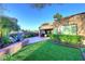 Lush backyard with green lawn, mature desert landscaping, patio area, and well-maintained privacy wall for a relaxing outdoor retreat at 7596 N Via De La Siesta --, Scottsdale, AZ 85258