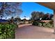 Landscaped backyard has a spacious brick patio and mature trees, creating a serene outdoor oasis at 7596 N Via De La Siesta --, Scottsdale, AZ 85258