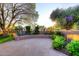 A tranquil backyard featuring a brick patio, lush greenery, and a mature shade tree, creating a serene outdoor space at 7596 N Via De La Siesta --, Scottsdale, AZ 85258