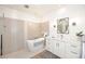 Modern bathroom with a freestanding tub, unique lighting, and neutral tile at 7596 N Via De La Siesta --, Scottsdale, AZ 85258