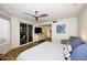 Spacious bedroom featuring a ceiling fan, wood floors, and glass doors leading to the outside at 7596 N Via De La Siesta --, Scottsdale, AZ 85258