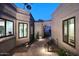 Charming courtyard with pavers, lush plants, and inviting views into the home's bright and airy interior at 7596 N Via De La Siesta --, Scottsdale, AZ 85258