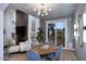 Charming dining area featuring a modern chandelier, fireplace, and sliding glass doors to the outdoor space at 7596 N Via De La Siesta --, Scottsdale, AZ 85258